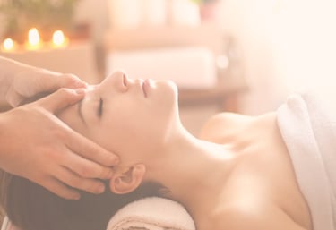 A relaxed woman receiving a calming facial head massage at Zen Massage Therapy Norfolk