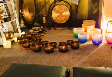 Studio with gongs and singing bowls on the floor in front of two pillows