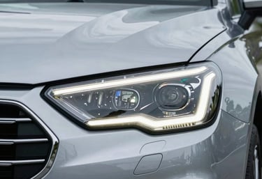 A close-up of a modern car headlight with LED accents, reflecting a clean North American suburban environment, sleek and technological look.