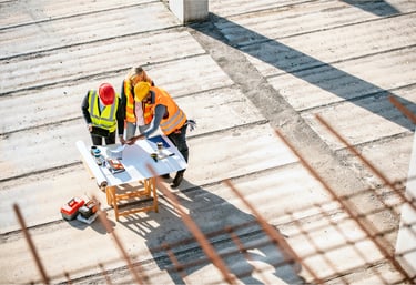 construction site support crews reviewing commercial project plans