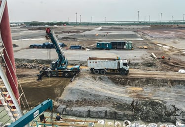 commercial sitework contractor loading materials on active infrastructure construction project Gulf 