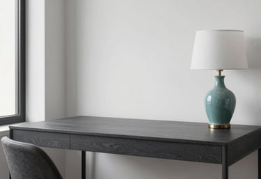 A minimalist, organized home office in a US apartment with a charcoal gray desk, a teal ceramic lamp, and clean white walls, professional design.