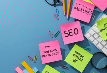 SEO strategy desk with sticky notes featuring indexing keywords, backlinks, and on-page optimization.