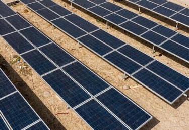 A bird's eye view of a neatly arranged residential solar system with battery storage. Professional, clean layout. Middle Eastern / Yemeni setting.