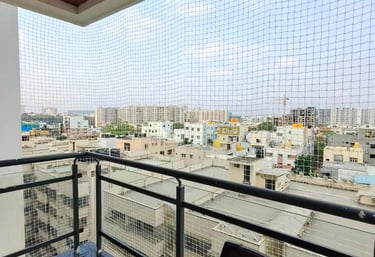 A family enjoying their balcony safely enclosed with a durable safety net.