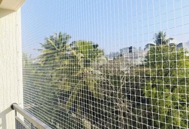Close-up of a freshly installed pigeon net securing a residential balcony.
