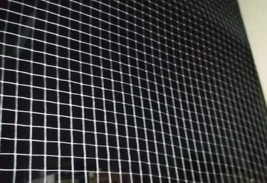 A close-up of a securely installed balcony safety net on a residential building in Adyar.