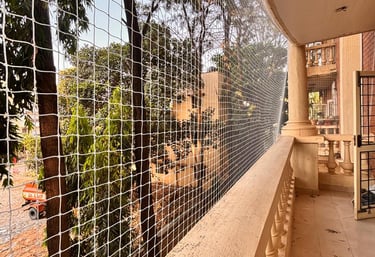 Close-up of a securely installed balcony safety net protecting a family home.