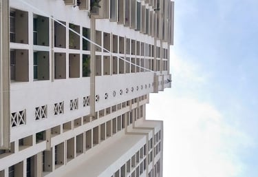 Wide view of an apartment building in Ambattur with installed safety nets on ducts.