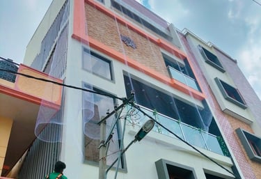 Technician carefully installing a pigeon net on a residential balcony in Kolathur.