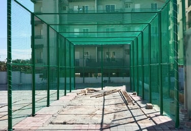 Close-up of durable sports netting stretched tightly across a rooftop space.