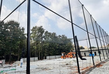 Wide shot of a freshly installed tennis court net under bright daylight.