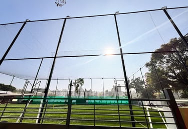 Hands tying knots on durable netting material, showcasing the craftsmanship behind each installation