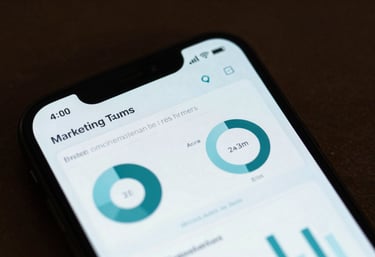 A high-end smartphone screen displaying a sophisticated marketing analytics dashboard with Muted Teal and Pale Sky Blue UI elements.
