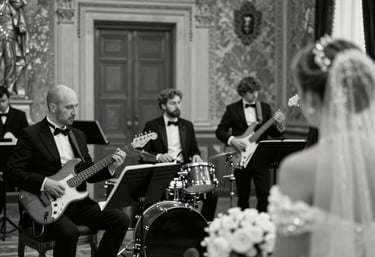 An elegant ensemble rehearsing in a minimalist, ivory-toned space with subtle black accents.