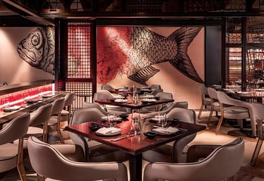 Modern Japanese restaurant interior with wooden tables and a large koi fish wall mural.