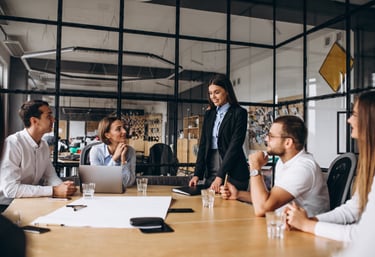 Professional team collaborating in a modern office meeting room during a corporate business presentation.