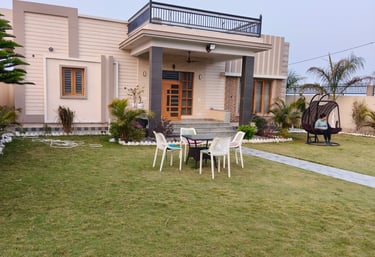 Modern luxury PG with a green lawn, outdoor patio furniture, and a balcony terrace.