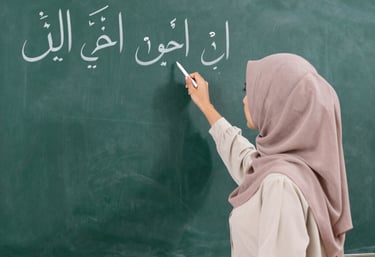 A professional female teacher in a green hijab guiding a student through Quranic recitation on a laptop screen.