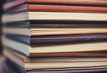Close-up of hands flipping through the pages of a freshly printed book.