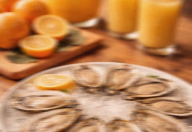 Fresh raw oysters on a bed of ice served with lemon and orange juice for a seafood brunch.
