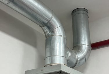 Technician carefully inspecting an air duct system with a camera in a bright, modern home.
