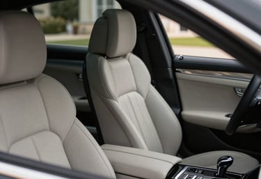 A luxury car interior featuring fine leather and polished accents, seen through an open window in French / Charente-Maritime.