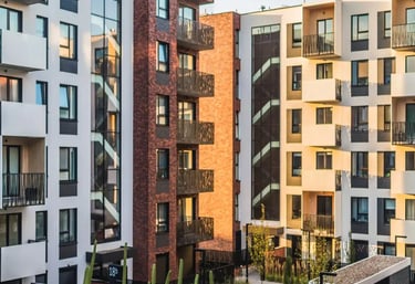 Modern residential apartment complex with landscaped courtyard and contemporary exterior design