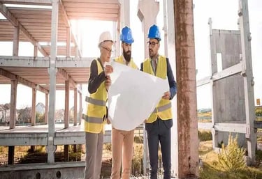 Engineers reviewing development plans at a land development project site