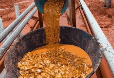 a bucket of food is being poured into a bucket