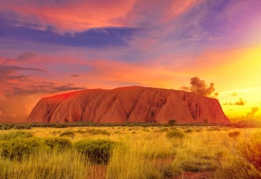 Uluru in Central Australia with the sun rising early in the morning after some rains