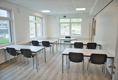 Feltec Paderborn a classroom with desks and chairs and a laptop