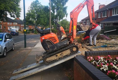 Mini digger being unloaded in Birmingham for groundwork services