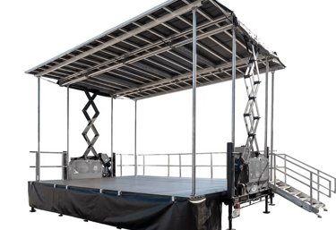 Portable mobile stage with a roof canopy and stairs for outdoor events and concerts.