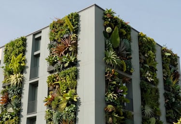 An architectural photograph of a modern green building featuring vertical gardens and clean exterior insulation panels in sage grey. Southern European style, bright daylight, emphasizing sustainable living.
