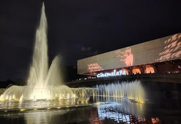 a fountain with a large screen showing a movie screen and a large screen with a