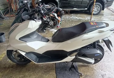 a motorcycle parked in a garage with a motorcycle
