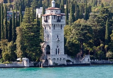 Torre San Marco reflected in Lake Garda, Gardone Riviera waterfront.