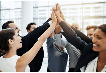 Team members high-fiving after completing a business milestone
