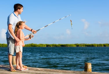 father daughter fishing on dock