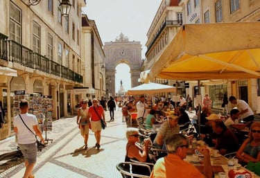 a group of people walking down a street with an arch in the background