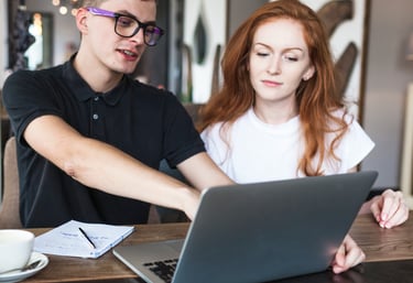 Freelance web designers collaborating in a co-working space, reflecting the early days of EZ Web Bui
