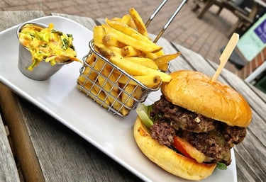 a tray of food on a table with a burger, slaw and fries