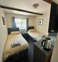 a bedroom with two beds and a coffee maker