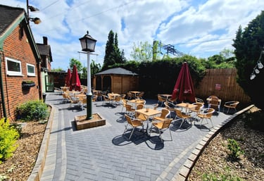 a patio with tables and chairs and umbrellas