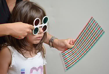 small girl using lens to read letters