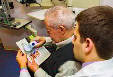 old man watching words through lens