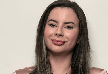 Hands holding a warm cup of tea, representing calm support and emotional grounding.