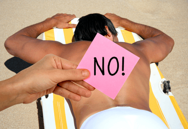 a man sitting on a beach chair with a note pad on his back