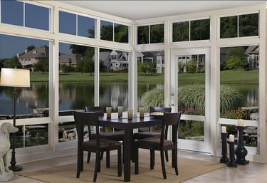 Three 3 seasons sunroom a dining room with a table and chairs